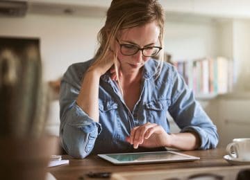 Image of young woman filing extension for her taxes on a tablet