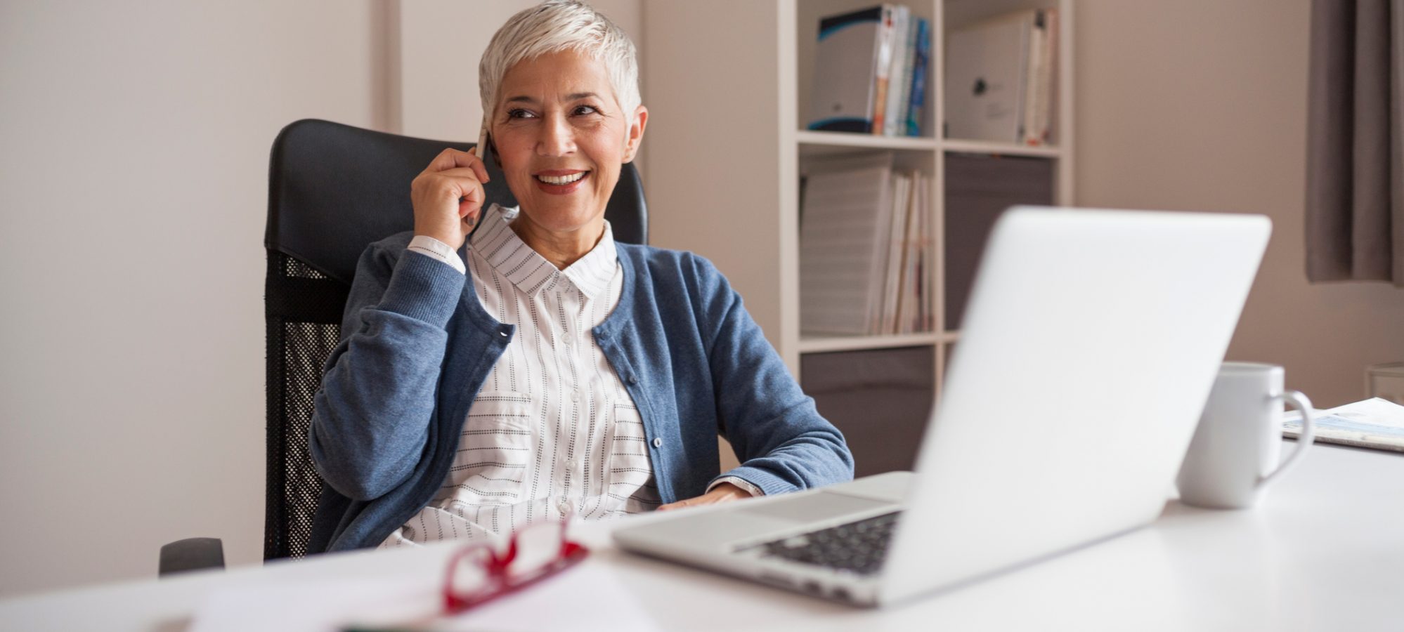 Image of a woman working from home and discussing home office deduction with her accountant