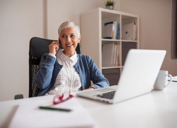 Image of a woman working from home and discussing home office deduction with her accountant