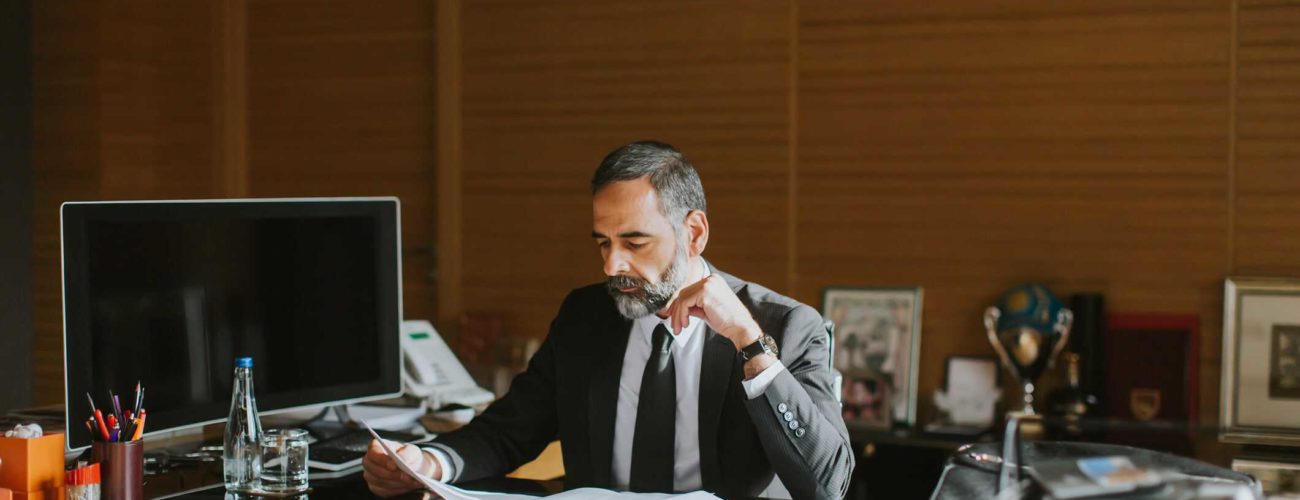 Image of business man working at desk in office