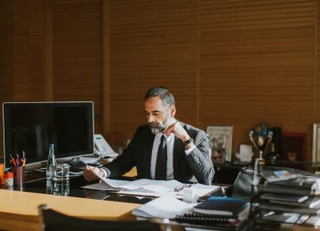 Image of business man working at desk in office