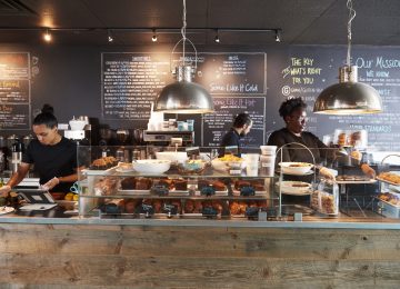 Image of minimum wage staff working behind counter in coffee shop