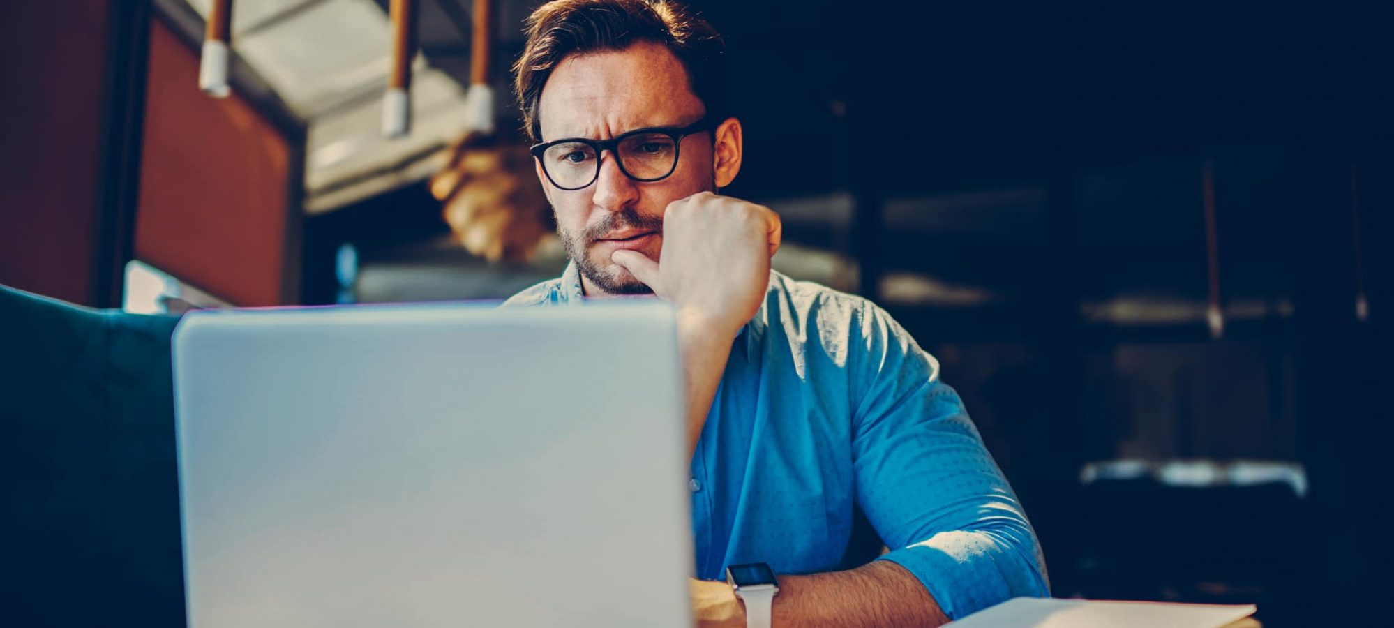 Business owner looking up the tax form he needs for QBI deduction on laptop