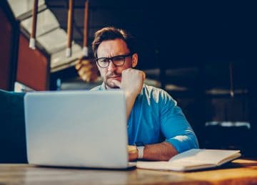 Business owner looking up the tax form he needs for QBI deduction on laptop