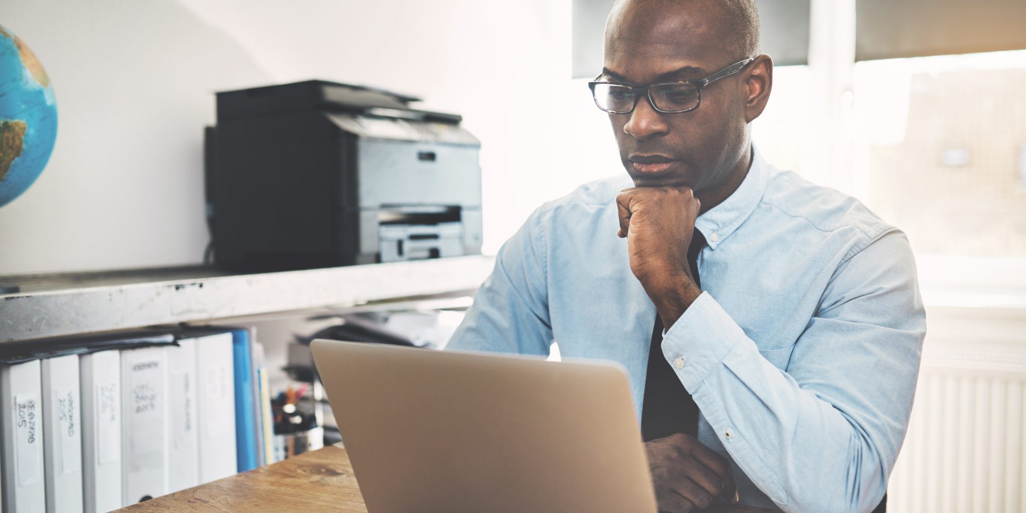 Businessman reading top 6 changes in Tax Cuts and Jobs Act on laptop