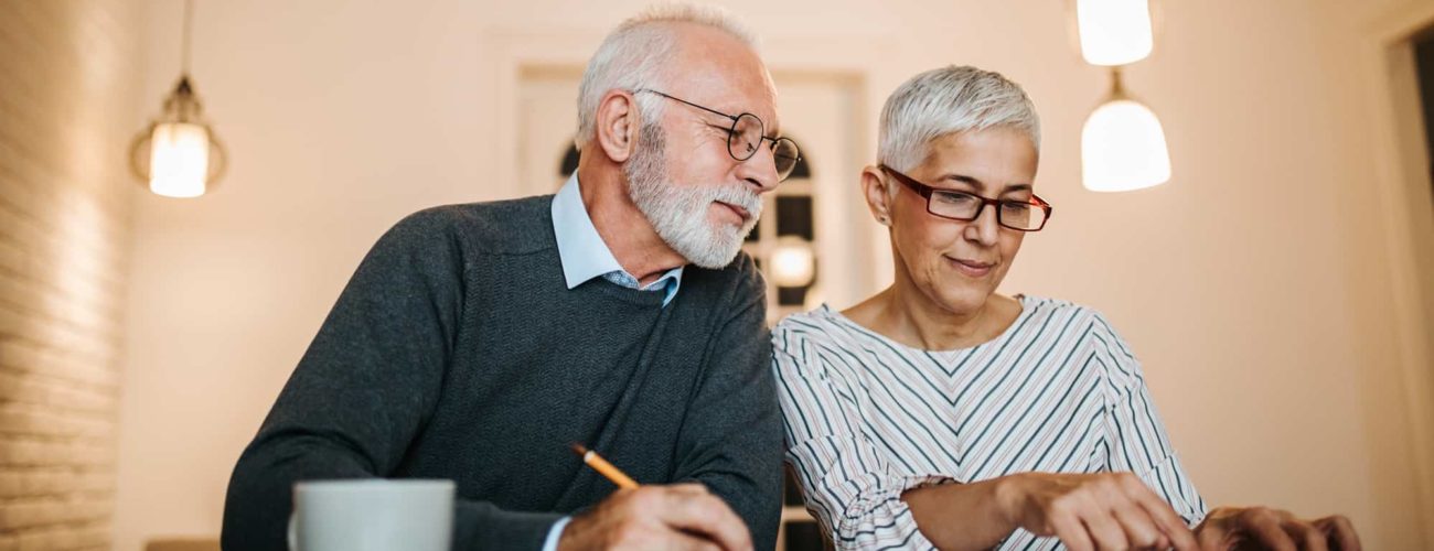 Mature couple reviewing new 2020 contribution limits for retirement