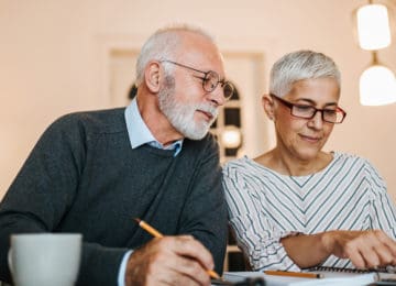 Mature couple reviewing new 2020 contribution limits for retirement